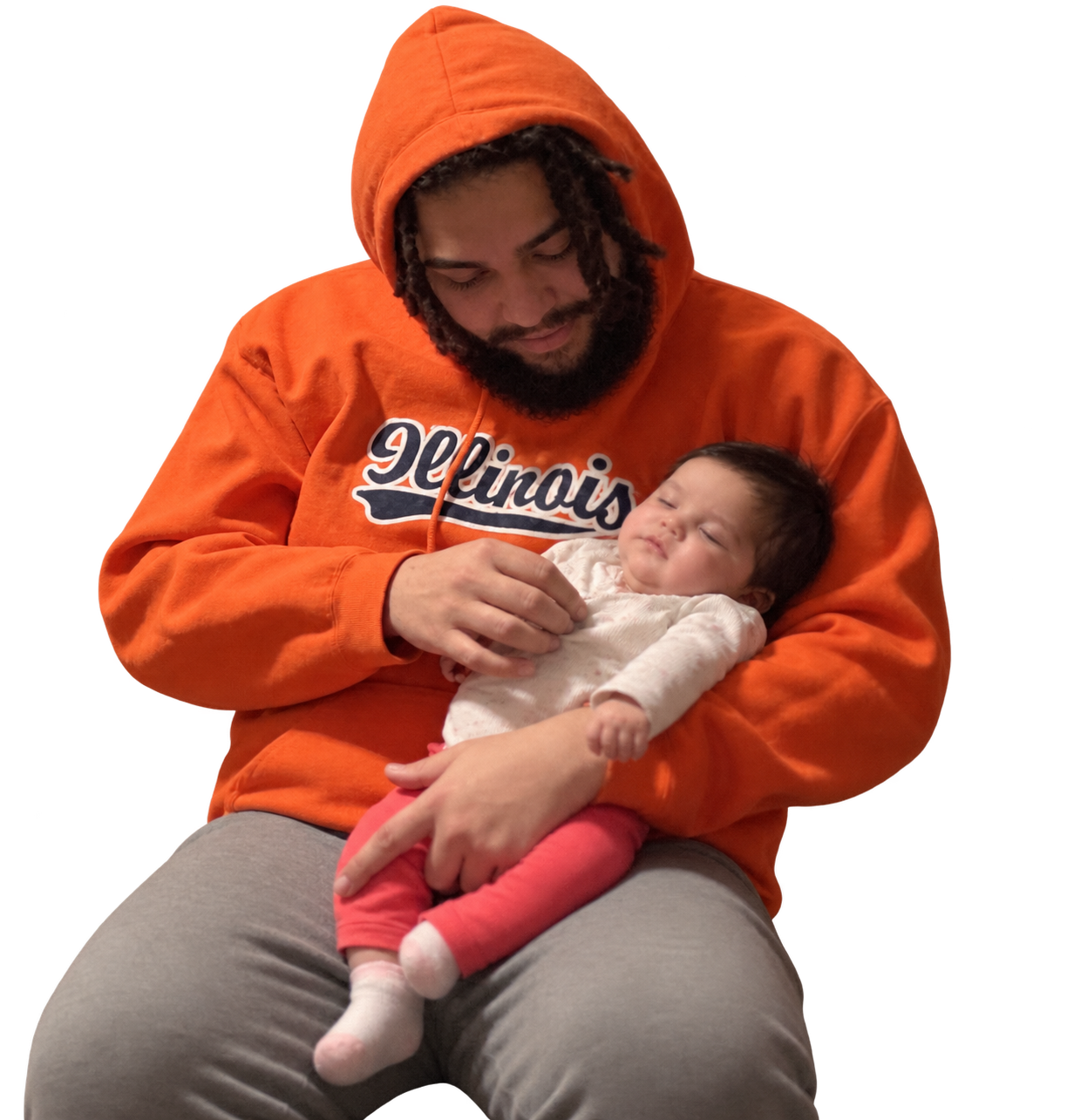 Tyler cradling his child in his arms