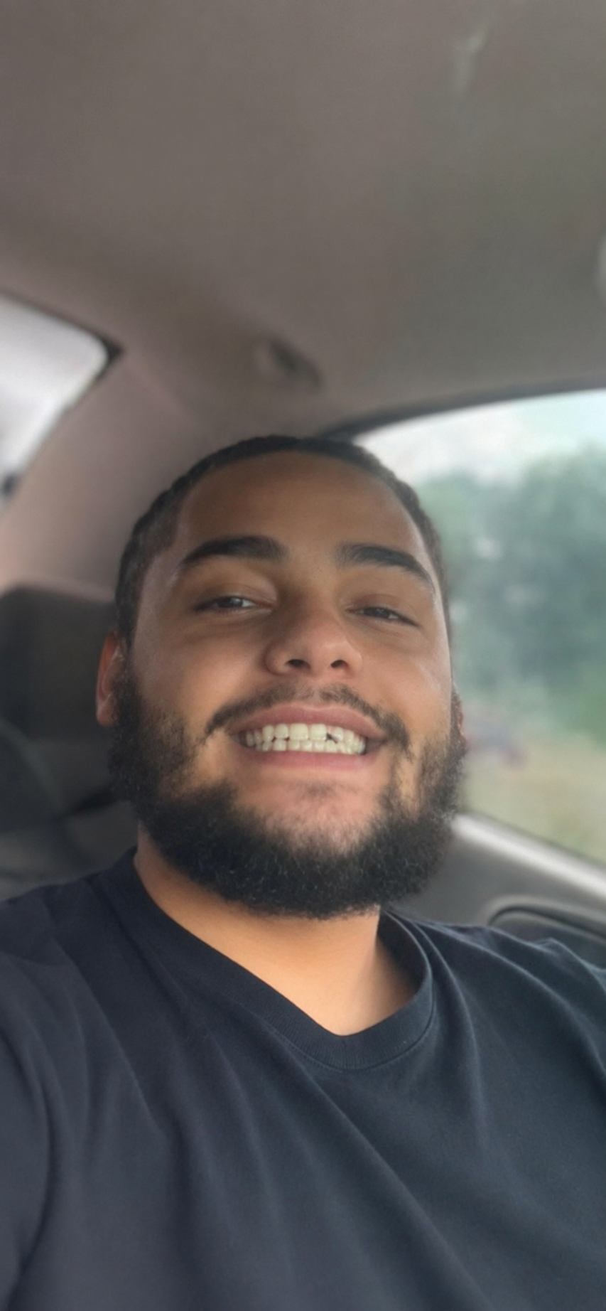 Tyler smiling in the car